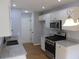 Updated kitchen features white cabinets, stainless steel appliances and granite countertops at 5815 Mountain Top Pl, Cumming, GA 30041