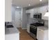 Updated kitchen features white cabinets, stainless steel appliances and granite countertops at 5815 Mountain Top Pl, Cumming, GA 30041