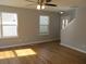 Bright and airy living room features hardwood floors, large windows, and neutral paint at 5815 Mountain Top Pl, Cumming, GA 30041