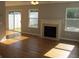 Living room features hardwood floors, a sliding glass door, and a fireplace at 5815 Mountain Top Pl, Cumming, GA 30041