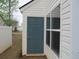 Exterior shot of shed with blue door and vinyl siding at 5815 Mountain Top Pl, Cumming, GA 30041