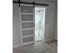 Elegant bathroom entry with a sliding barn door, and luxurious glass shower at 1427 Lorenzo Sw Dr, Atlanta, GA 30310