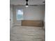 Bright bedroom with wood floor, a modern ceiling fan, and a view to the outside at 1427 Lorenzo Sw Dr, Atlanta, GA 30310