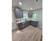 Modern kitchen with gray cabinets, stainless steel appliances, and hardwood floors, ready for cooking at 1427 Lorenzo Sw Dr, Atlanta, GA 30310