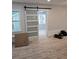 Bright living space featuring a sliding barn door and light wood flooring at 1427 Lorenzo Sw Dr, Atlanta, GA 30310