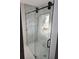 Modern walk-in shower with marble-look wall tiles, and sleek glass enclosure at 1427 Lorenzo Sw Dr, Atlanta, GA 30310