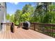 A wooden deck features an outdoor grill and seating at 208 Julia Lynn Ln, Acworth, GA 30102