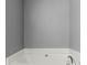Close up on tub with crystal faucet, grey walls and white finishes at 208 Julia Lynn Ln, Acworth, GA 30102