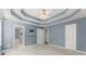 Spacious bedroom features a trey ceiling with crown molding, soft lighting, and ensuite bathroom at 208 Julia Lynn Ln, Acworth, GA 30102