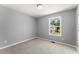 An empty bedroom features a neutral carpet and a bright window at 208 Julia Lynn Ln, Acworth, GA 30102