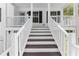 Inviting front porch with classic white railings and stained brown wood steps at 208 Julia Lynn Ln, Acworth, GA 30102