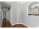 View of hallway featuring wood floors and archway with a view into kitchen at 208 Julia Lynn Ln, Acworth, GA 30102