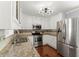 Updated kitchen with stainless steel appliances, granite countertops, and modern lighting at 208 Julia Lynn Ln, Acworth, GA 30102
