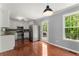 Bright kitchen features stainless steel appliances, white cabinets, granite countertops, and hardwood floors at 208 Julia Lynn Ln, Acworth, GA 30102
