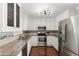 Well-lit kitchen features stainless steel appliances, granite counters, and white cabinets at 208 Julia Lynn Ln, Acworth, GA 30102