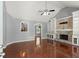 Open-concept living room features hardwood floors, fireplace, and built-in shelving at 208 Julia Lynn Ln, Acworth, GA 30102
