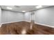 An open living space showcases sleek wood floors and neutral walls at 208 Julia Lynn Ln, Acworth, GA 30102