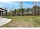 Expansive backyard with lush lawn and tree line, offering privacy and space at 2107 E Maddox Rd, Buford, GA 30519