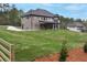 Large yard, covered patio, and view of exterior features at 2107 E Maddox Rd, Buford, GA 30519