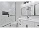 Bathroom featuring glass-enclosed shower, marble tile, and modern vanity with black fixtures at 2107 E Maddox Rd, Buford, GA 30519