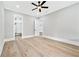 Well-lit bedroom with hardwood floors and an open door to a custom closet at 2107 E Maddox Rd, Buford, GA 30519