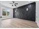 Spacious bedroom features a modern accent wall, ample natural light, and views of the surrounding landscape at 2107 E Maddox Rd, Buford, GA 30519