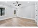 Spacious bedroom with hardwood floors, ceiling fan, and natural light from large windows at 2107 E Maddox Rd, Buford, GA 30519