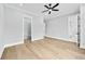 Light-filled bedroom featuring wood floors and access to a closet and en-suite bathroom at 2107 E Maddox Rd, Buford, GA 30519