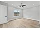 Minimalist bedroom with natural light from a large window and hardwood flooring at 2107 E Maddox Rd, Buford, GA 30519