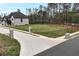New construction showing white brick and black trim with a pristine lawn and landscaping at 2107 E Maddox Rd, Buford, GA 30519