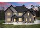 Charming two-story home featuring a brick facade, covered entrance, and well-manicured lawn at 2107 E Maddox Rd, Buford, GA 30519