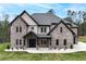 Charming two-story home featuring a brick facade, covered entrance, and well-manicured lawn at 2107 E Maddox Rd, Buford, GA 30519