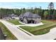 New construction showing brick and stone exterior with a pristine lawn and landscaping at 2107 E Maddox Rd, Buford, GA 30519
