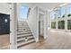 Grand foyer with staircase, high ceilings, hardwood floors, and abundant natural light at 2107 E Maddox Rd, Buford, GA 30519