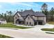 Stunning new construction with a three-car garage, manicured lawn, and a concrete driveway at 2107 E Maddox Rd, Buford, GA 30519