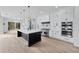 Modern kitchen with stainless steel appliances, center island, and custom white cabinetry at 2107 E Maddox Rd, Buford, GA 30519