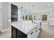Modern kitchen with large center island, contrasting cabinets and view to Gathering room with fireplace at 2107 E Maddox Rd, Buford, GA 30519