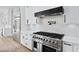 Modern gourmet kitchen boasts stainless appliances, custom cabinets, and stone countertops at 2107 E Maddox Rd, Buford, GA 30519