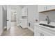 Laundry room features light gray tiles and a white sink at 2107 E Maddox Rd, Buford, GA 30519