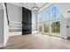 Living room boasts expansive windows, a stunning fireplace, and custom built-in shelving at 2107 E Maddox Rd, Buford, GA 30519