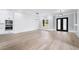 Elegant living room featuring decorative wall trim, wood floors, and modern light fixture at 2107 E Maddox Rd, Buford, GA 30519