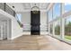 Bright living room with large windows, modern fireplace, and custom shelving at 2107 E Maddox Rd, Buford, GA 30519