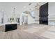 An open-concept living space with island, staircase, fireplace, and white paint is elegant at 2107 E Maddox Rd, Buford, GA 30519