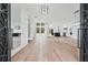 Spacious living room with wood floors, large windows, and modern lighting fixtures at 2107 E Maddox Rd, Buford, GA 30519