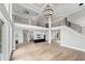 Open living space features a modern kitchen, staircase, and second-floor overlook with grand windows at 2107 E Maddox Rd, Buford, GA 30519