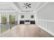 Cozy loft area with fireplace, built-in cabinets, and hardwood floors, ideal for relaxing or entertaining guests at 2107 E Maddox Rd, Buford, GA 30519