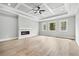 Bright main bedroom with natural light, fireplace, ceiling fan, and hardwood floors, designed for comfort and style at 2107 E Maddox Rd, Buford, GA 30519