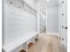 Stylish mudroom with built-in bench, coat hooks, and hardwood floors at 2107 E Maddox Rd, Buford, GA 30519