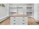 Walk-in closet with custom shelving, drawers, and wooden floors at 2107 E Maddox Rd, Buford, GA 30519
