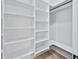 Walk-in closet featuring custom shelving, and lighting creating ample storage space at 2107 E Maddox Rd, Buford, GA 30519